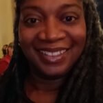 A close-up selfie of a woman smiling
