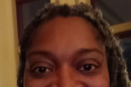 A close-up selfie of a woman smiling