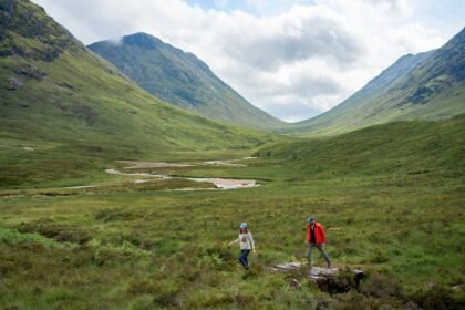 Dramatic Scottish Highlands landscape with rolling green hills and moody clouds