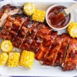 Grilled ribs and corn with bbq sauce.