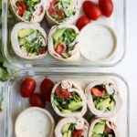 Turkey Avocado Wrap Lunch with tomato and lettuce in meal prep container