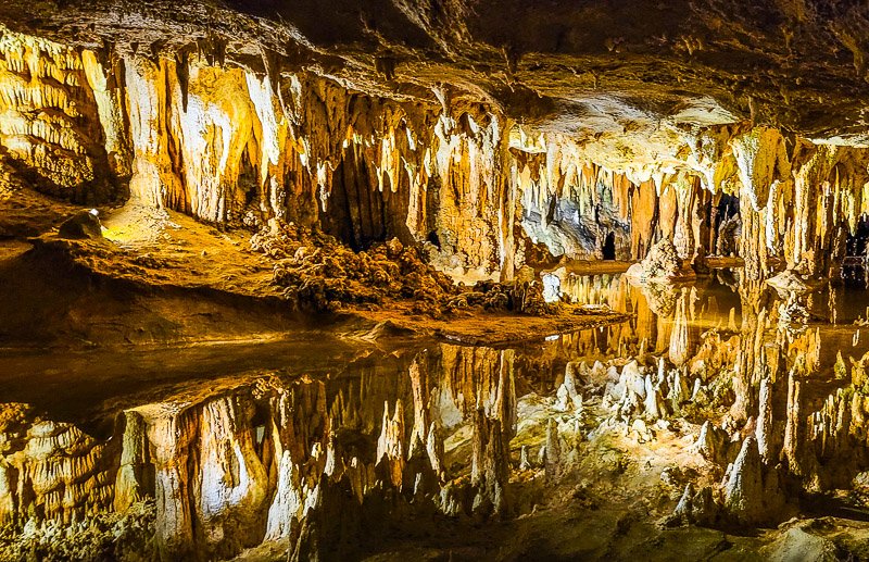 cavern with water and stalagmites and stalagtites