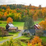 Vermont fall foliage with lively red and orange trees covering the hillside