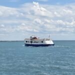 Chicago water taxi stops - cruising across Lake Michigan on a sunny day, operated by Shoreline Sightseeing with passengers enjoying views from the upper deck.
