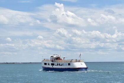 Chicago water taxi stops - cruising across Lake Michigan on a sunny day, operated by Shoreline Sightseeing with passengers enjoying views from the upper deck.