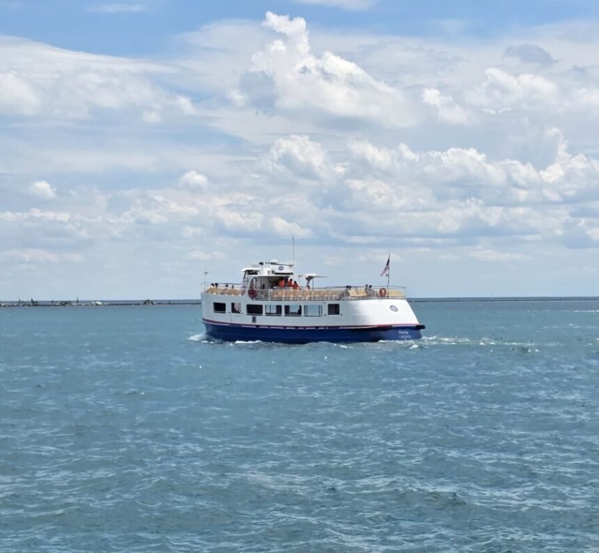 Chicago water taxi stops - cruising across Lake Michigan on a sunny day, operated by Shoreline Sightseeing with passengers enjoying views from the upper deck.