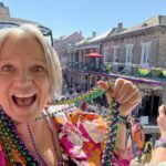 Megan ready to throw beads to the folks below on Bourbon Street