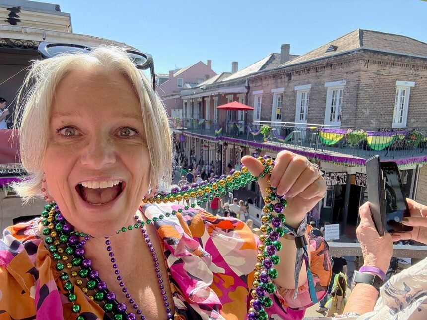 Megan ready to throw beads to the folks below on Bourbon Street