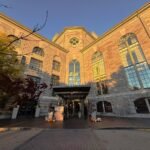 The Liberty Hotel Boston entrance with the sun shining on its historic bricks