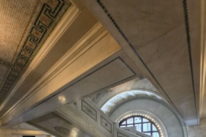 Intricate marble staircase and detailed mosaic accents inside the historic Chicago Cultural Center.