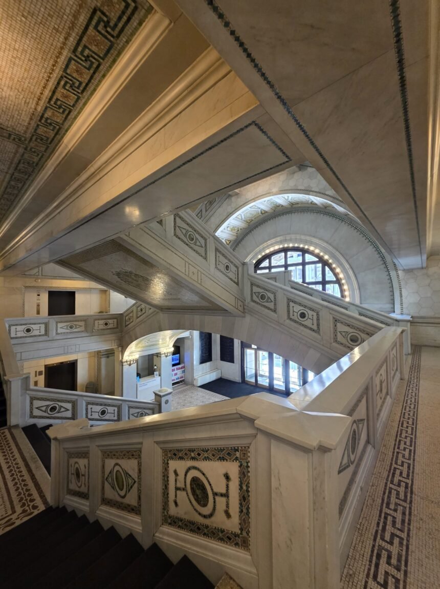 Intricate marble staircase and detailed mosaic accents inside the historic Chicago Cultural Center.