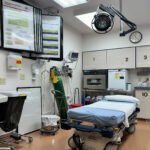 A photo of a small emergency room. Only one bed is visible.