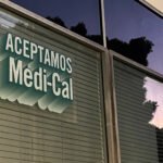 A sign printed on a window reads "Aceptamos Medi-Cal."