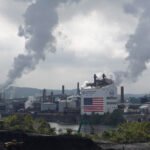 A view of the Clairton Plant and Clairton Coke Works facilities along the Monongahela River. Smog billows out of smokestacks from both facilities.