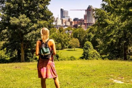 woman looking at raleigh skyline view from dix park