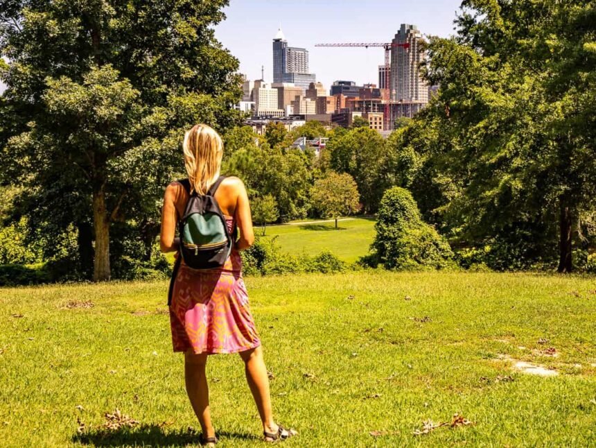 woman looking at raleigh skyline view from dix park