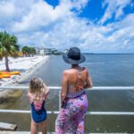 woman and child standing on pier looking at cedar key beach