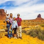 makepeace family standing in front of the mittens at monument valley