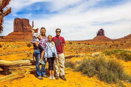 makepeace family standing in front of the mittens at monument valley