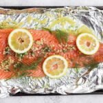 A full salmon fillet marinating in lemon dill salmon marinade
