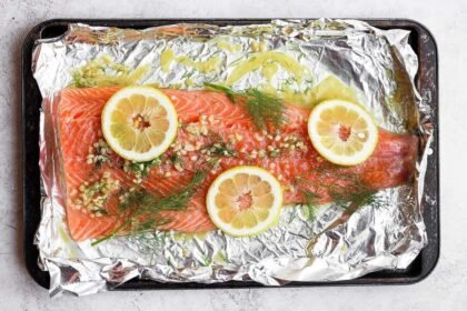 A full salmon fillet marinating in lemon dill salmon marinade